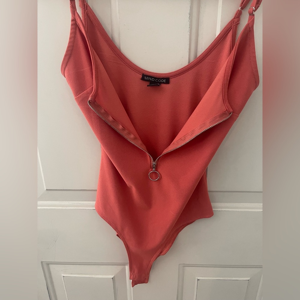 Pink/orangish colored body suit